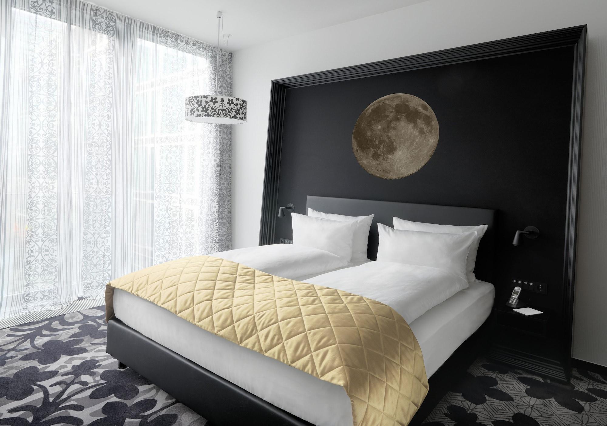 Kameha Grand Bonn Bona Quarto foto A bed with a duvet